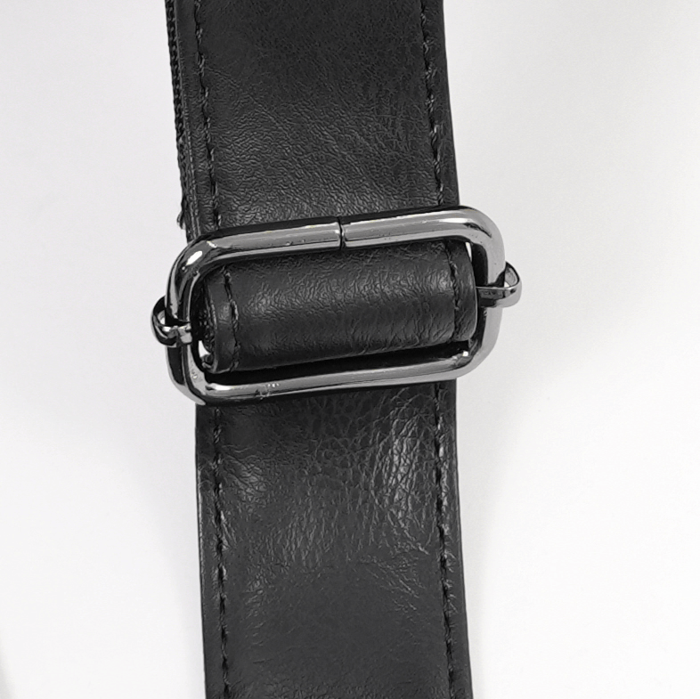 Close-up of the black tote bag strap featuring a sleek chrome buckle for a stylish and secure fit.