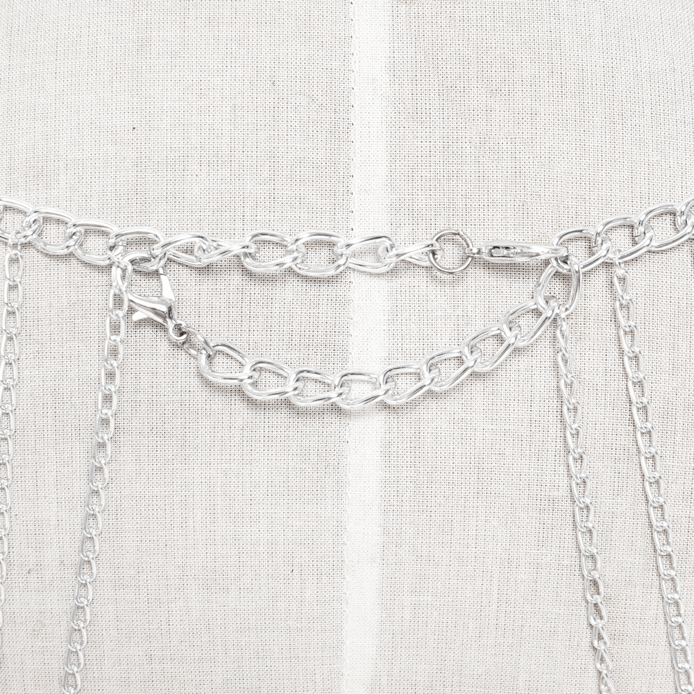 Close-up of a silver metal gothic chain headpiece with cascading chains and spiked details for punk fashion.