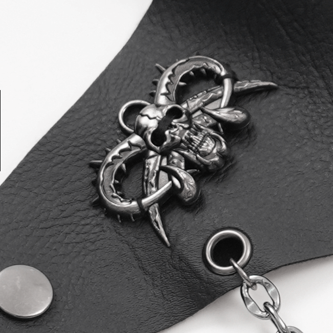 Gothic skull and thorn design on black leather wrist cuff, featuring a chain link for punk style fashion.