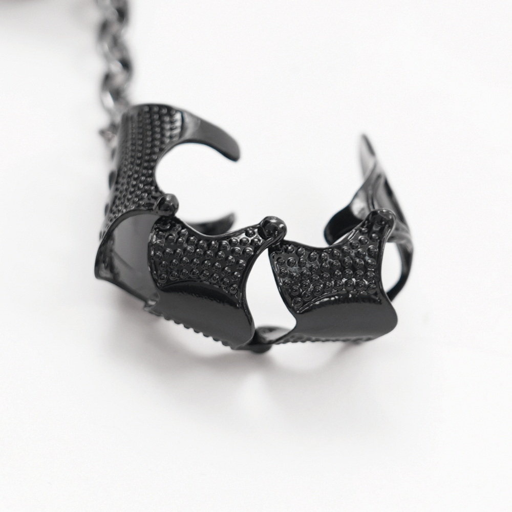 Gothic chain-link finger claw ring in black metal, showcasing intricate punk-inspired design.