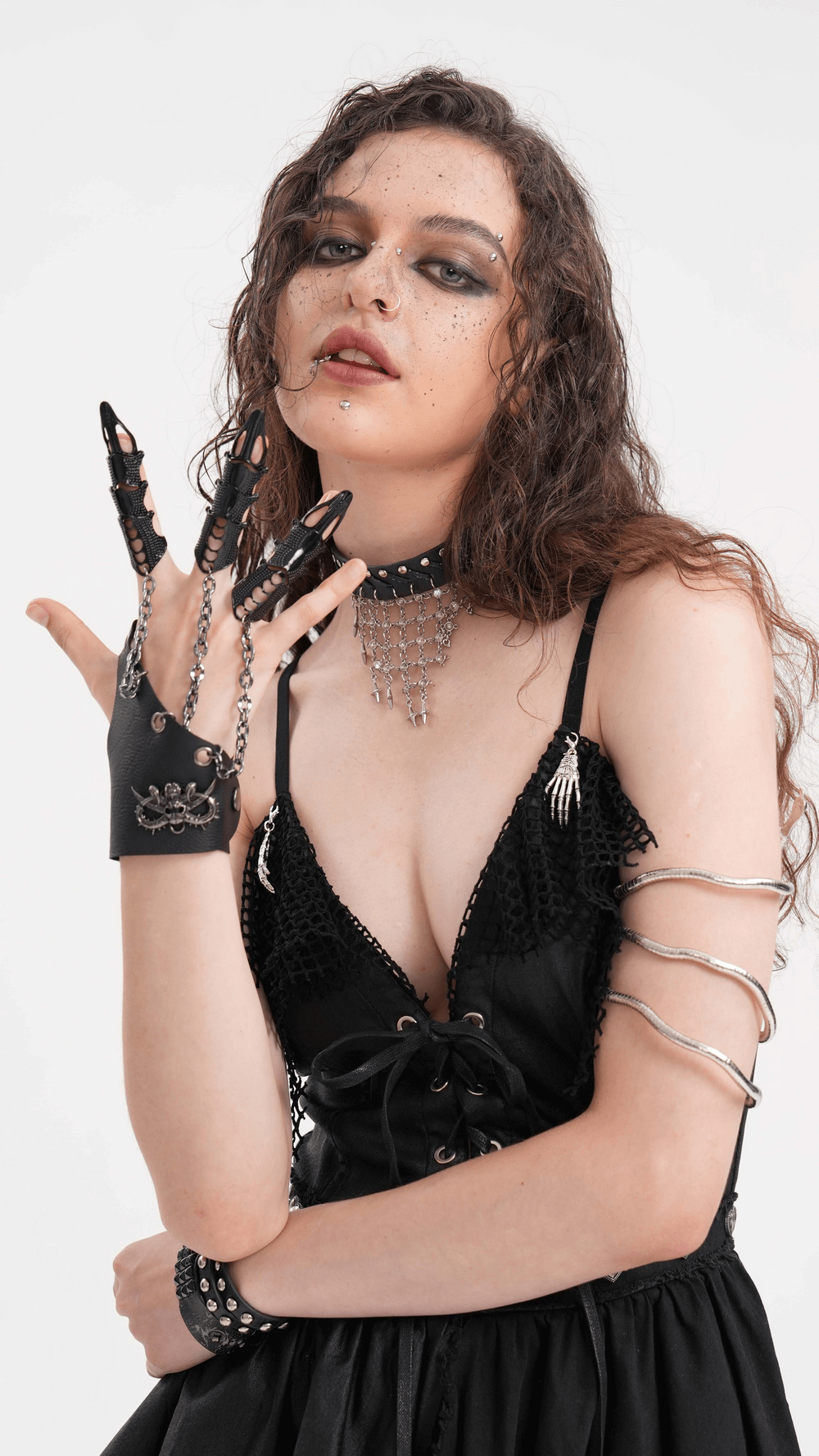 Model showcasing gothic chain-link finger claws and leather wrist cuff, embodying punk aesthetic.
