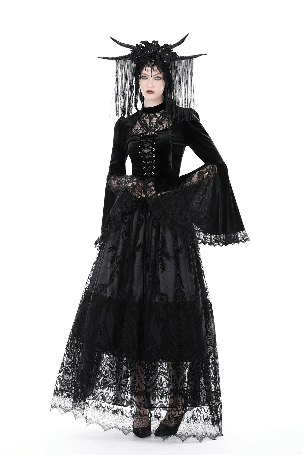 Model wearing a gothic chic black lace maxi skirt with dramatic bell sleeves and intricate floral details.