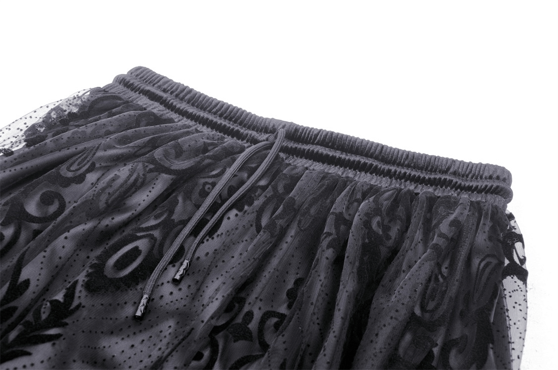 Close-up of Gothic chic black lace maxi skirt with dramatic flocked damask pattern and elastic waistband.