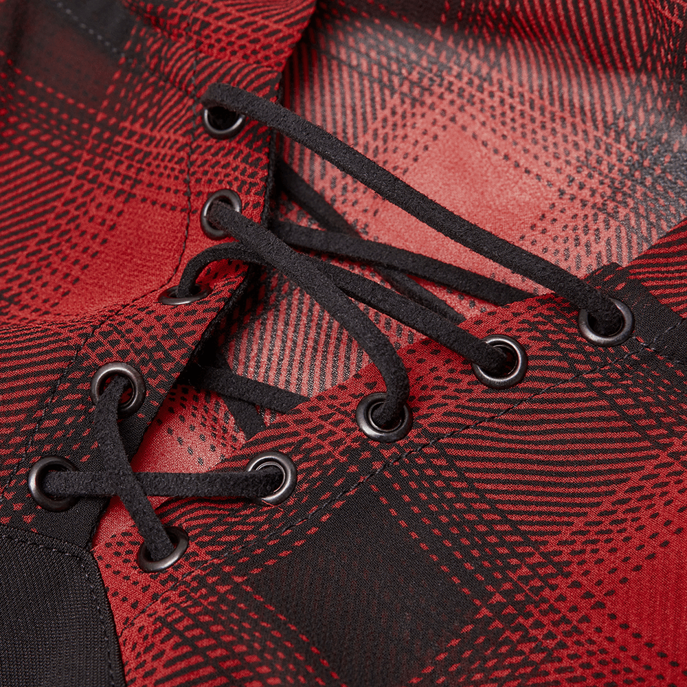Close-up of the lace-up collar on a black and red plaid mini dress with edgy details.