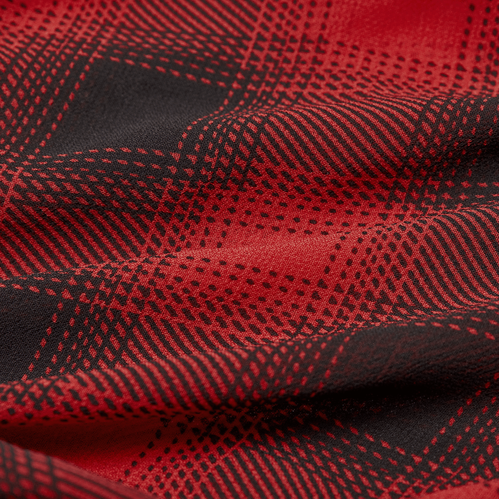 Close-up of black and red plaid fabric, showcasing the edgy pattern for Gothic Chic style.