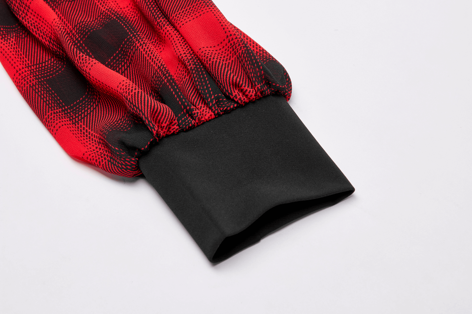 Close-up of the black cuff detail of a Gothic plaid hooded mini dress with red and black pattern.