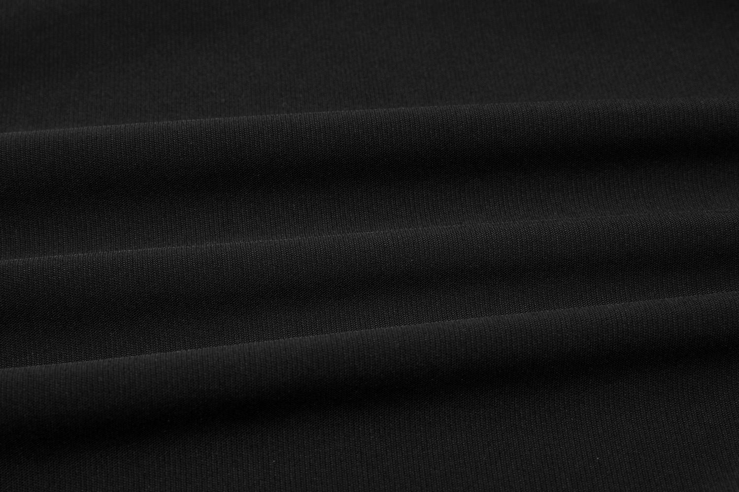 Close-up of soft black fabric with smooth folds, perfect for edgy gothic fashion.