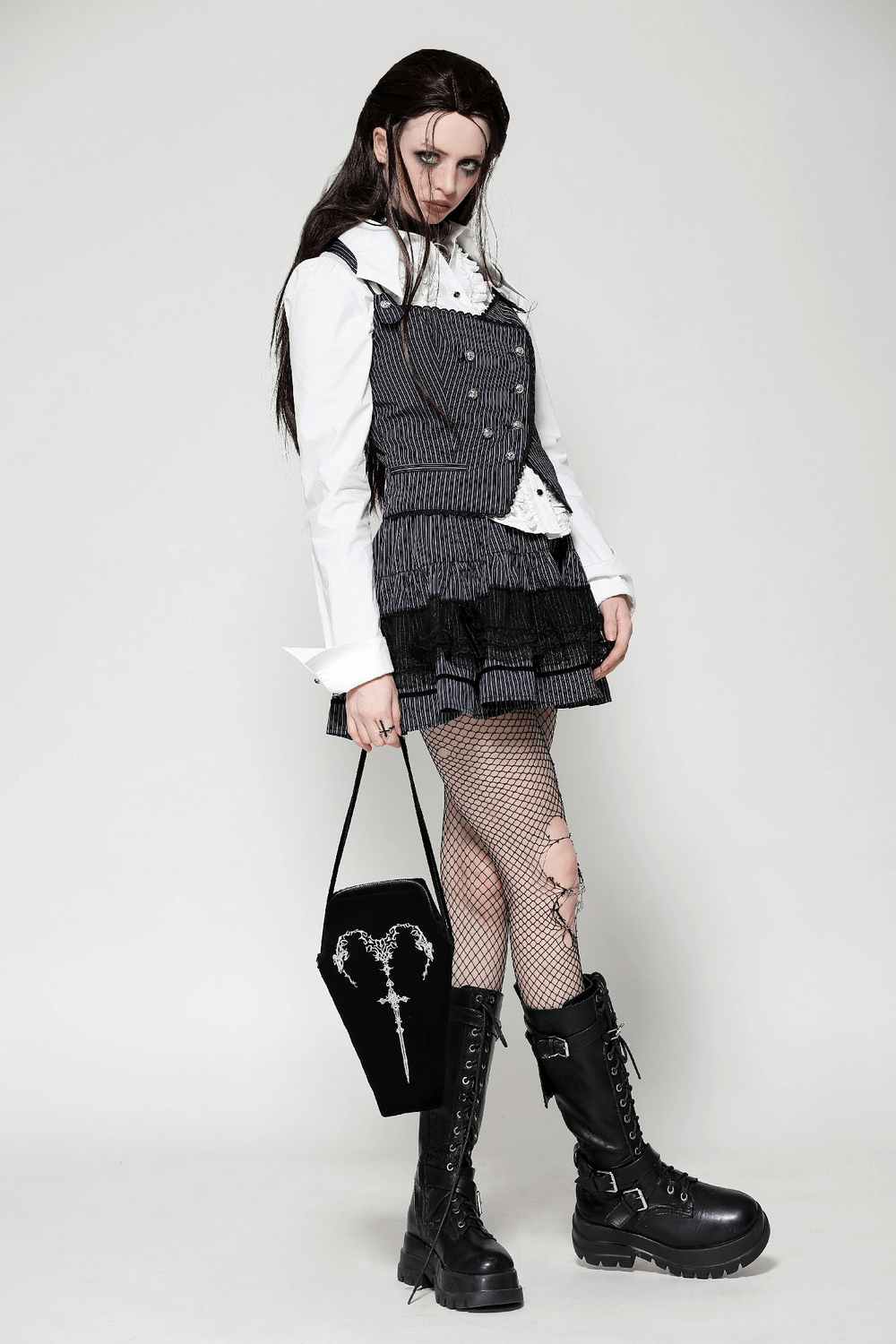 Model in gothic outfit showcasing a coffin shoulder bag with embroidered sword design, styled for dark aesthetics.