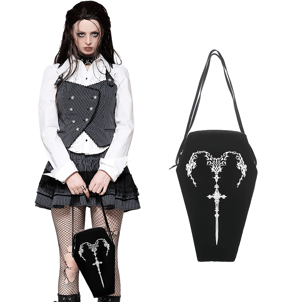 Gothic coffin shoulder bag with embroidered sword design worn by model in dark aesthetic outfit.