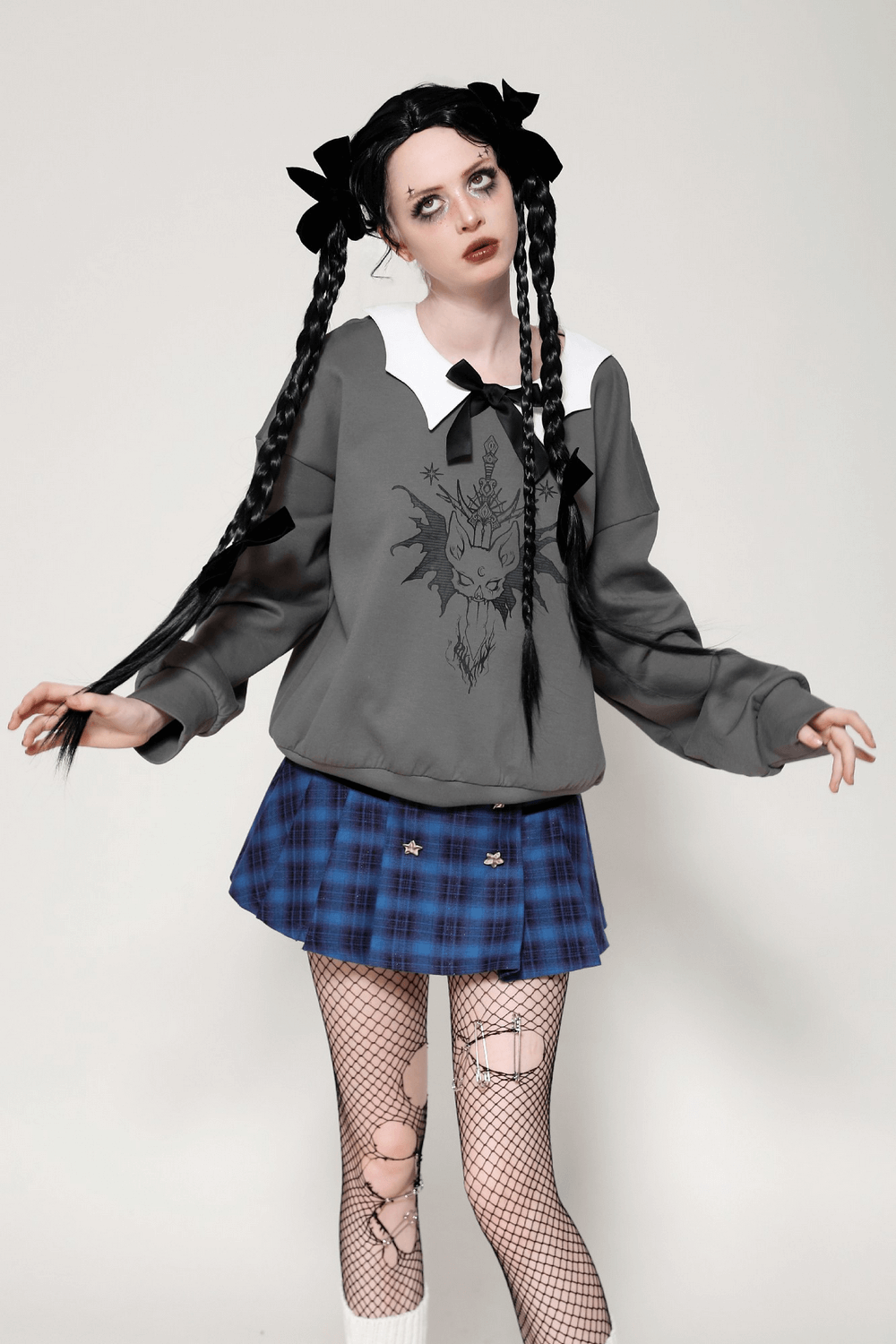 Gothic collar bow sweatshirt with unique cat design, paired with a blue plaid skirt and fishnet tights, showcasing dark elegance.