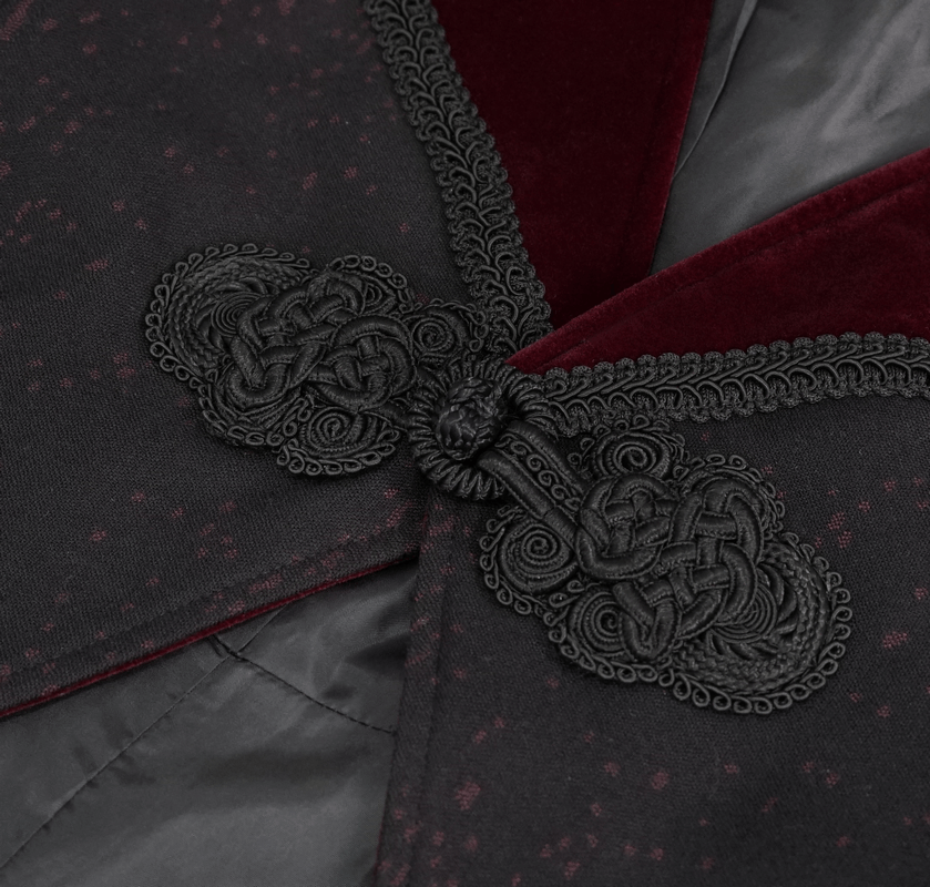 Close-up of intricate gothic embroidery on black coat collar with burgundy accents.