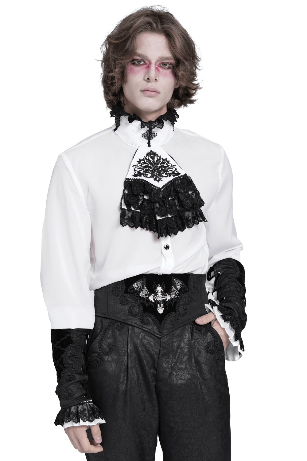 Gothic fashion model in white shirt with black lace details and pants, showcasing vampiric style attire.