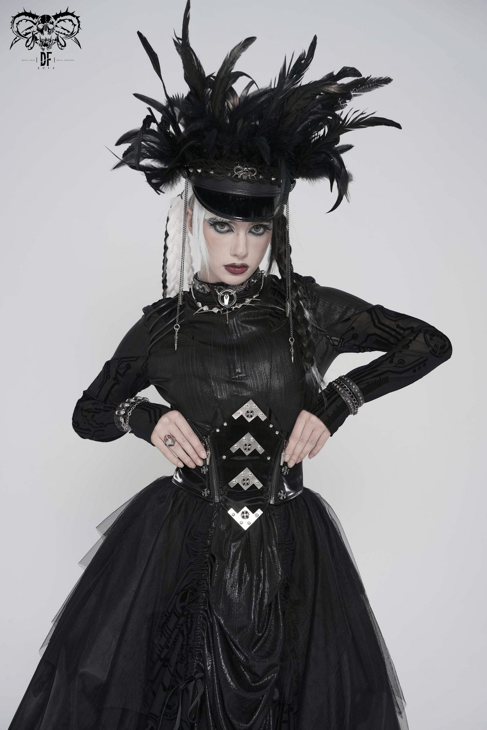 Gothic Corset Belt with Metal Cross Stud Details Trim worn by model in dramatic black attire and feathered hat.