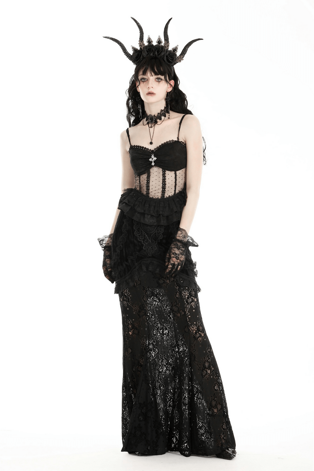 Elegant gothic model in a black lace corset dress with ruffles and dramatic accessories for a dark, romantic look.