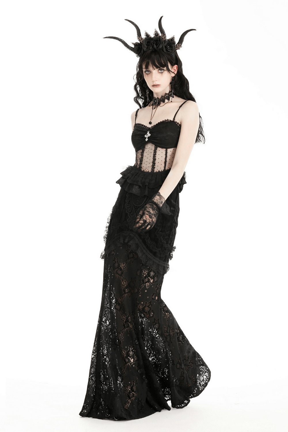 Gothic model in elegant black lace gown with corset and dramatic horned headpiece, showcasing dark elegance.