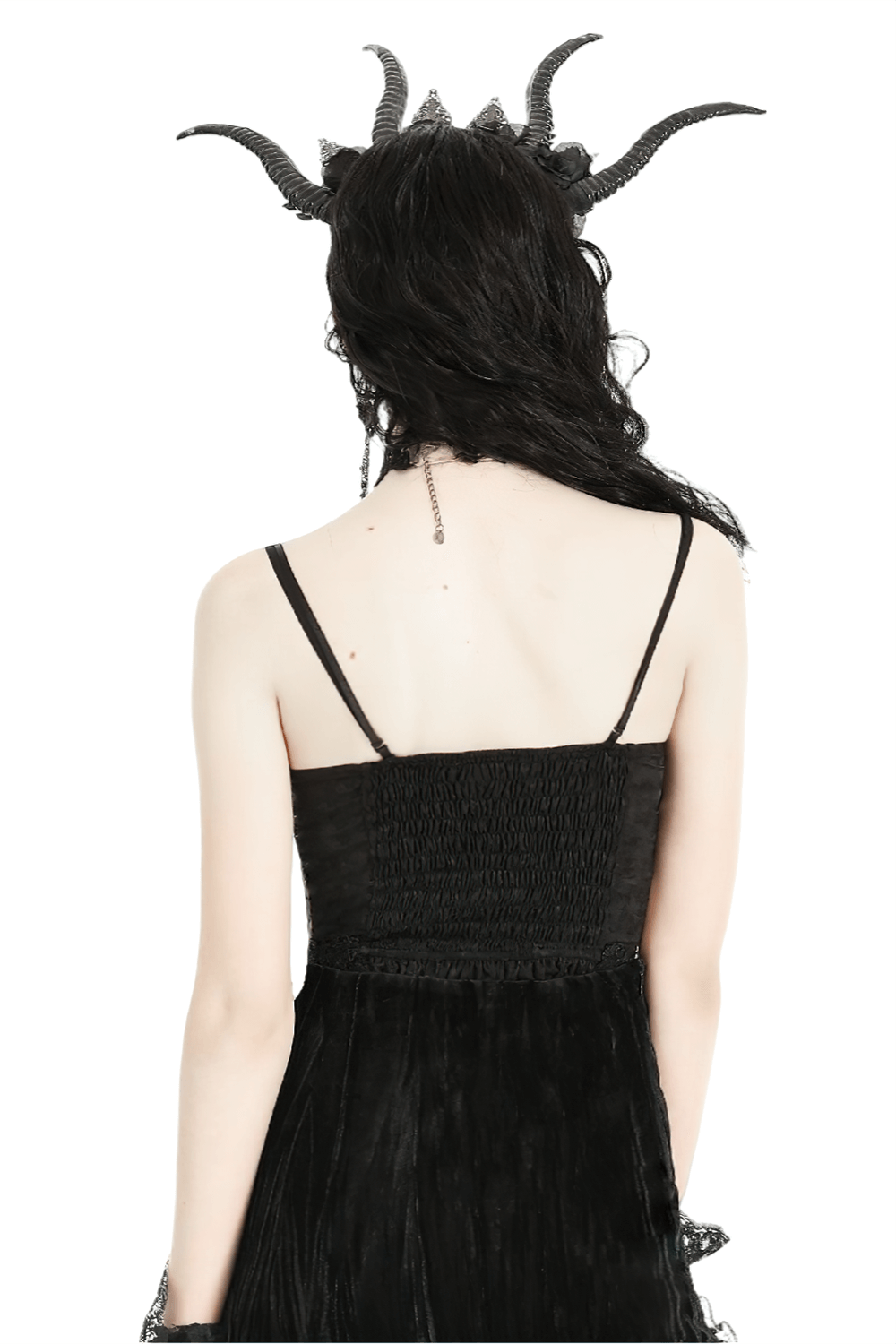 Back view of a gothic model wearing a black corset dress with a dramatic horned headpiece.