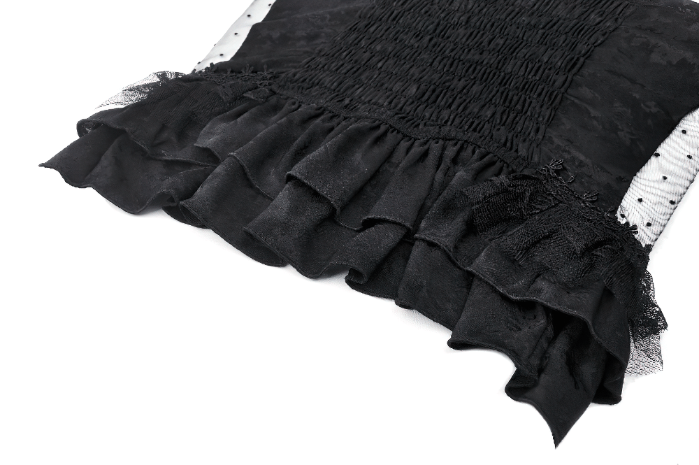 Close-up of a Gothic corset top featuring black lace, polka dot detailing, and elegant ruffles.