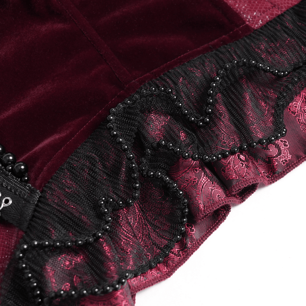 Burgundy gothic corset close-up with black lace trim, beads, and ruffled hem for dramatic elegance.