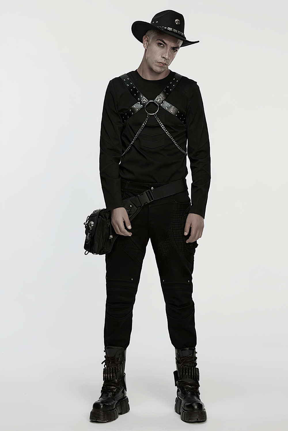 Stylish model in a black harness shirt and gothic cowboy hat, perfect for punk and alternative fashion enthusiasts.