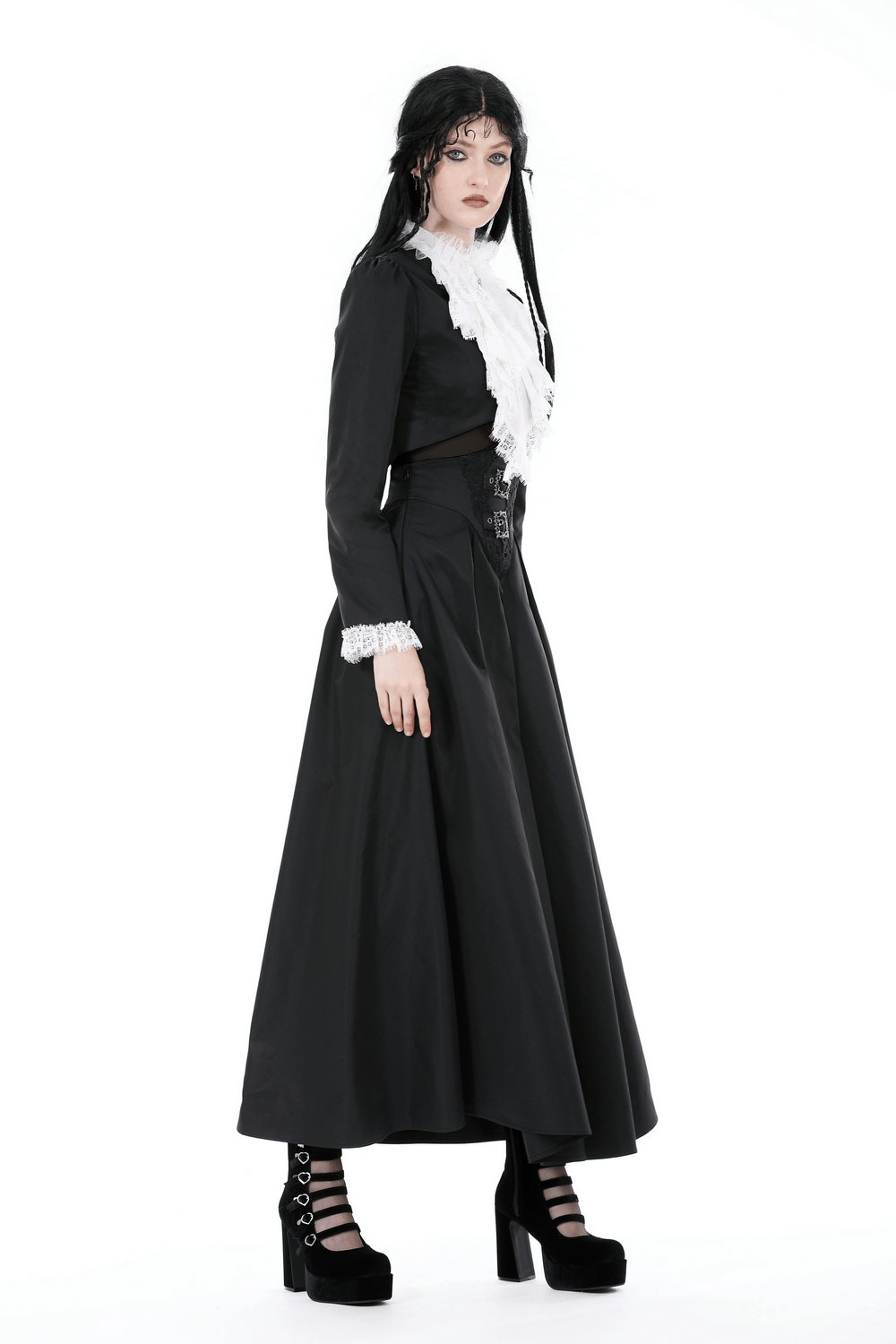 Gothic cropped lace jacket with white ruffle collar worn with a long black skirt and platform boots.