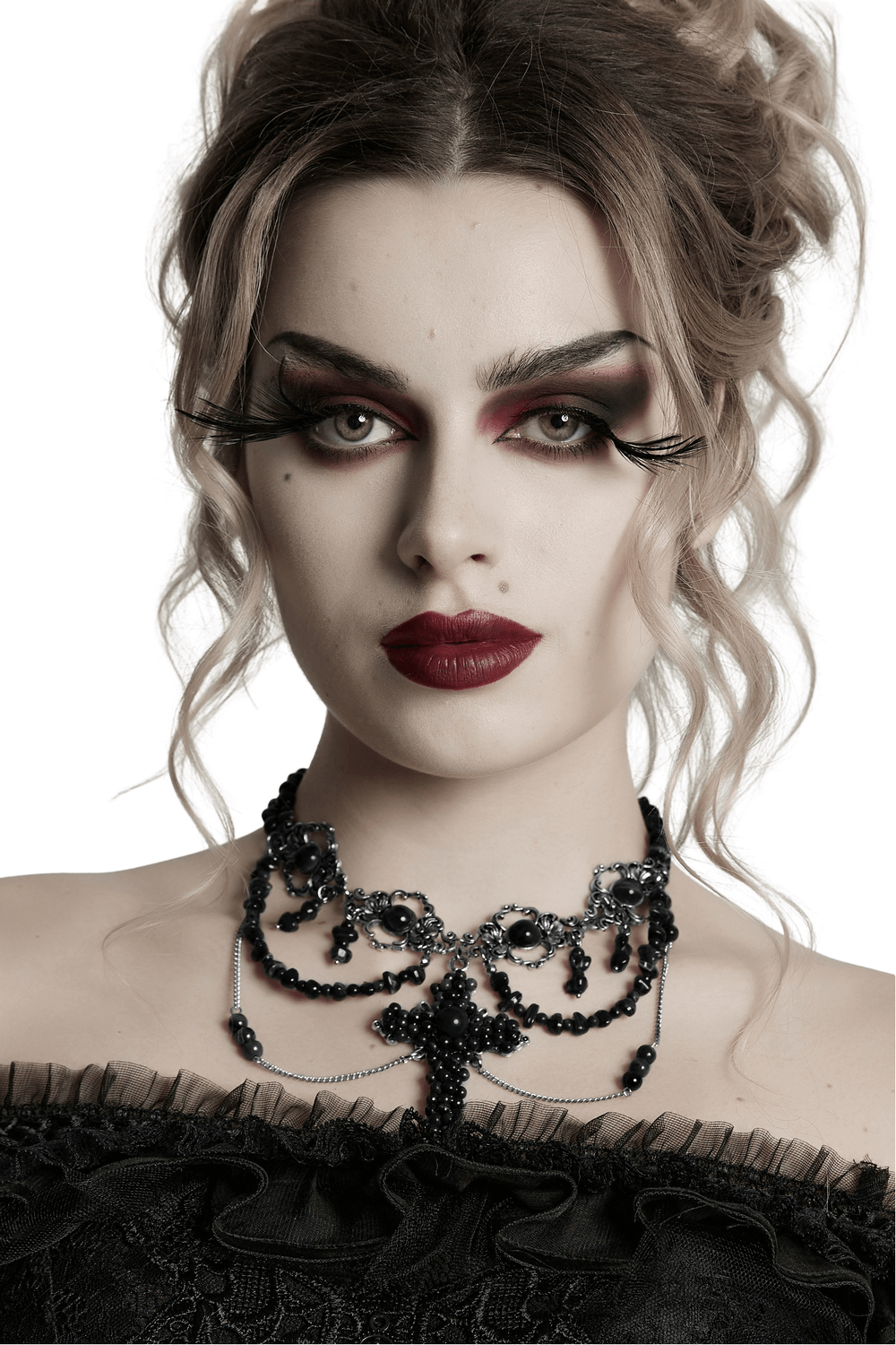 Gothic cross necklace with black beads worn by a model with dramatic makeup and hairstyle, exuding vintage elegance.