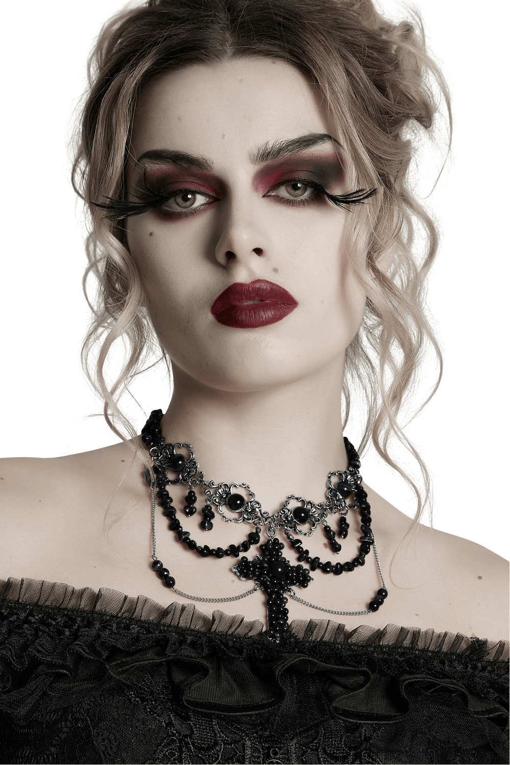 Gothic cross necklace with black beads, alloy chains, and unique vintage design on model.