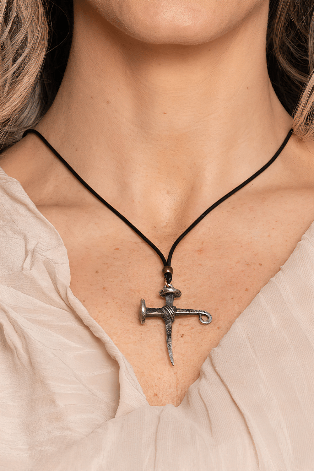 Gothic Cross of Nails Pewter Amulet Necklace Pendant worn on a black cord, showcasing its medieval design and protective symbolism.