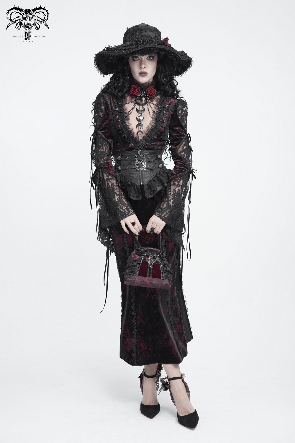 Gothic Cross Velvet Handbag with Ruffle Trim Details held by a model in a Victorian Gothic outfit with dramatic flair.