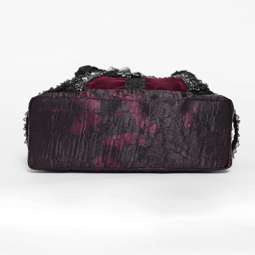 Gothic Cross Velvet Handbag with Ruffle Trim Details showcased from the bottom, featuring rich black and burgundy textures.