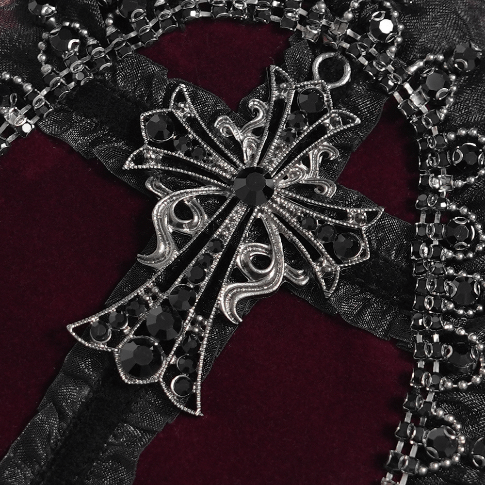 Gothic Cross Velvet Handbag with Ruffle Trim Details featuring an ornate silver cross on black textured fabric.