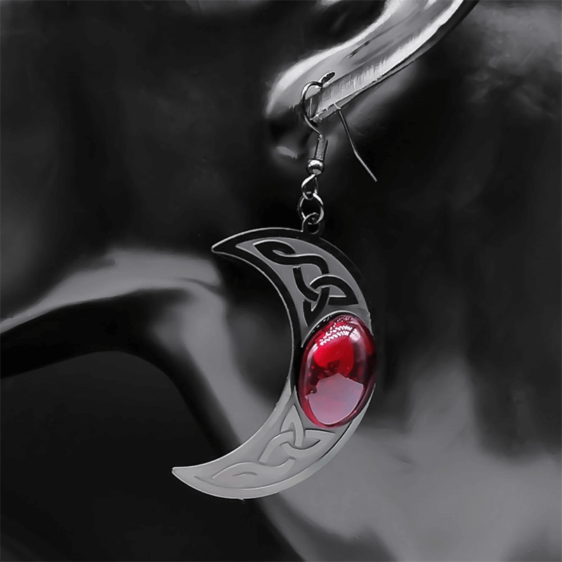 Gothic dark Celtic earring featuring a stainless steel crescent design with a striking red stone.