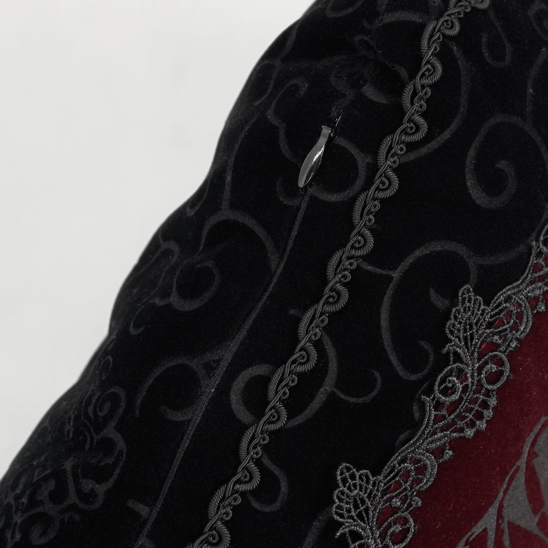 Close-up of black gothic coffin-shaped cushion featuring intricate T-lace trim and elegant velvet texture.
