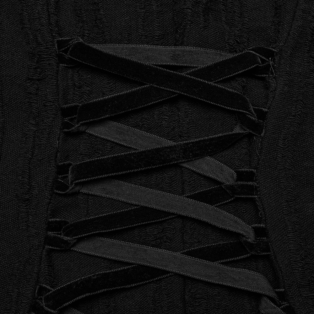 Close-up of black lace-up detail on gothic dress with velvet straps and textured fabric.