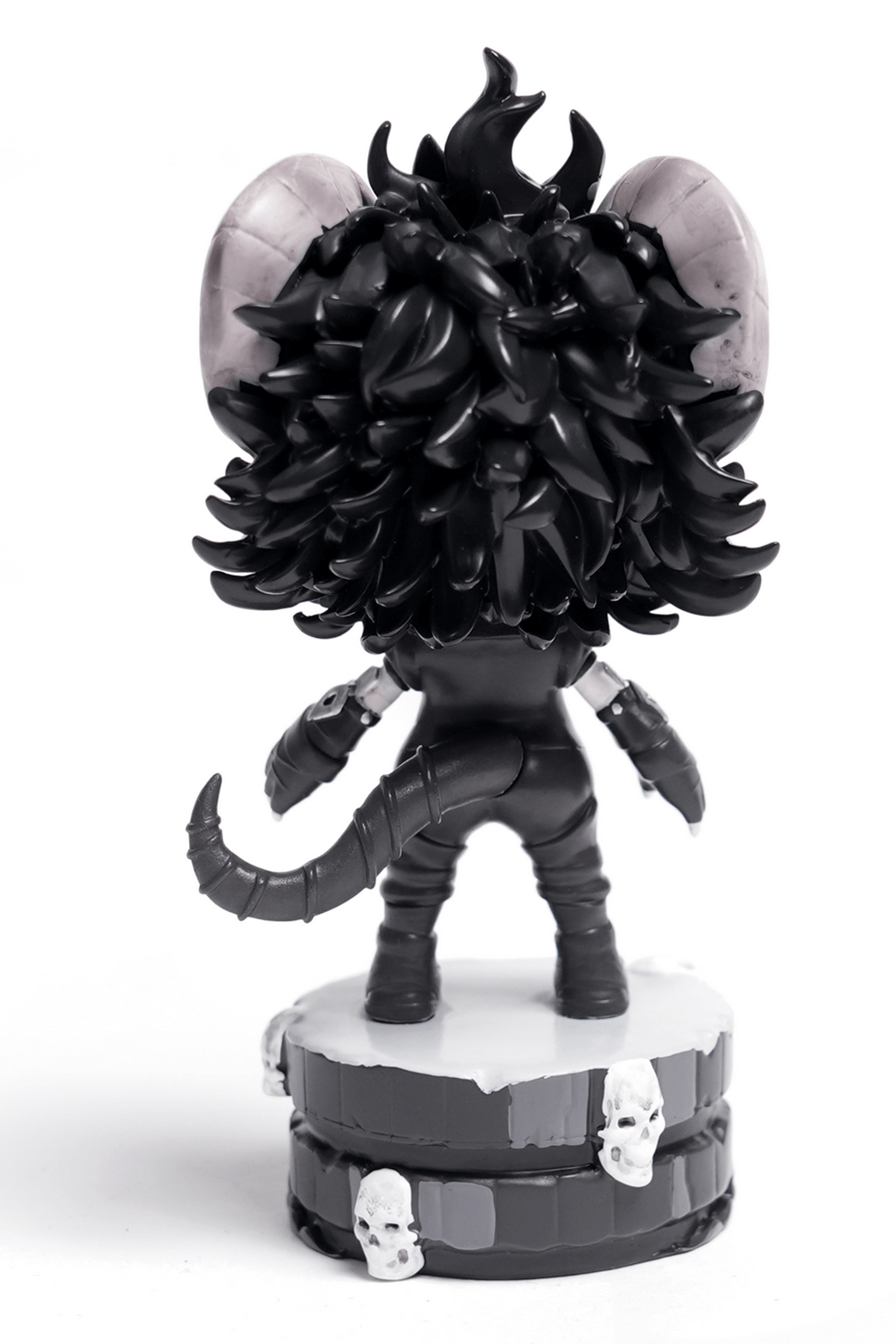 Back view of a gothic demon figure with horns, stylish black hair, and a skull-adorned base.