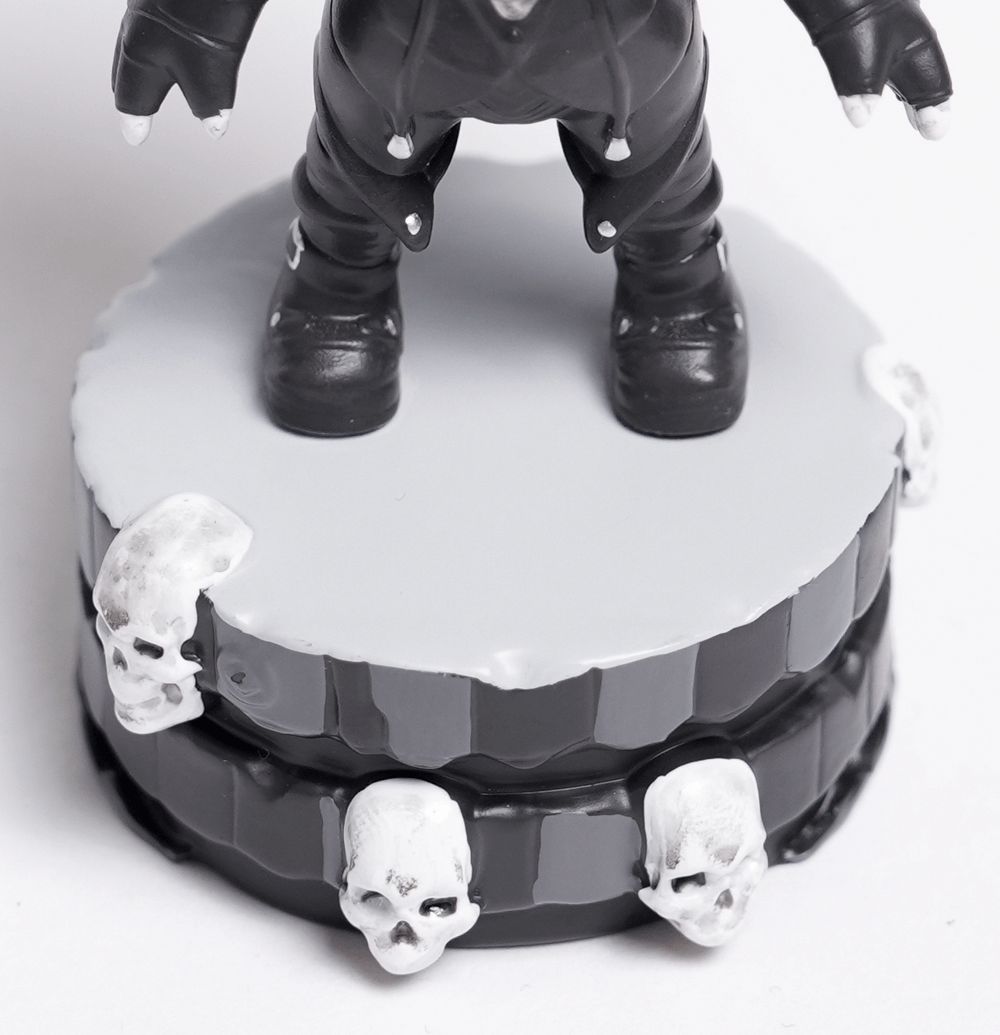 Gothic demon figure with horns standing on a skull-adorned base, perfect for collectors and spooky decor.