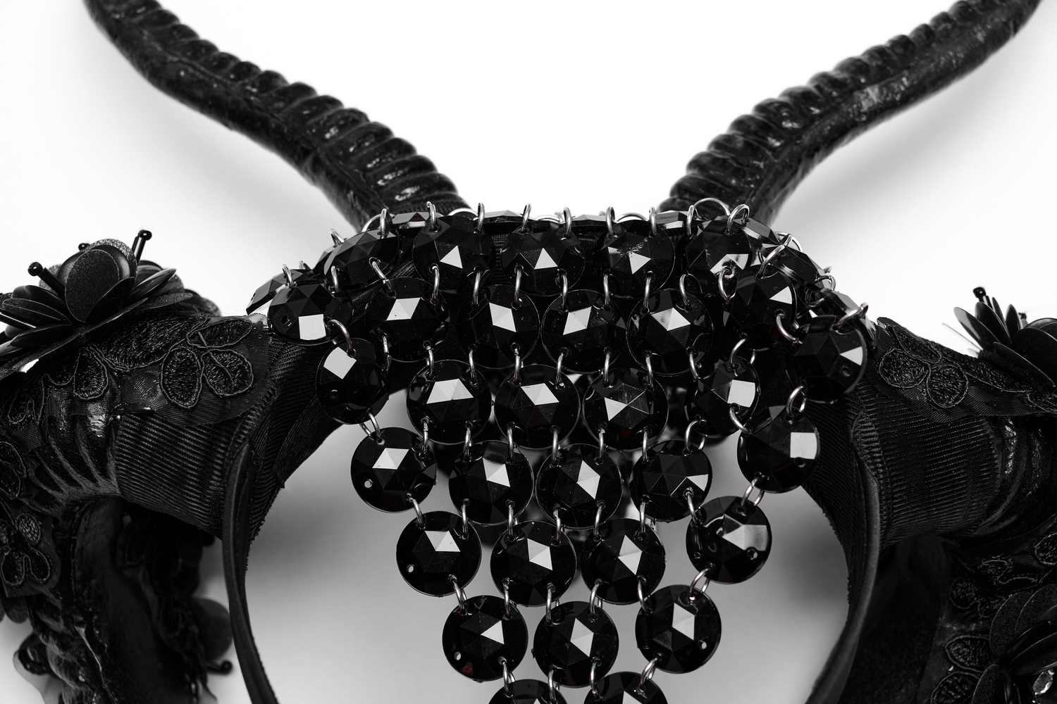 Gothic demon horn headwear adorned with glittering flowers and black acrylic embellishments.