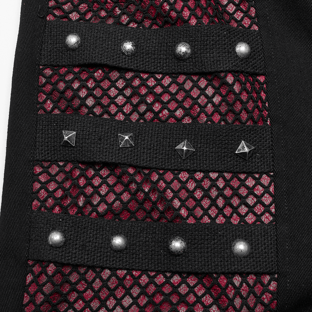 Close-up of Gothic style mesh panel with detachable faux leather straps and metal rivets in punk trousers.