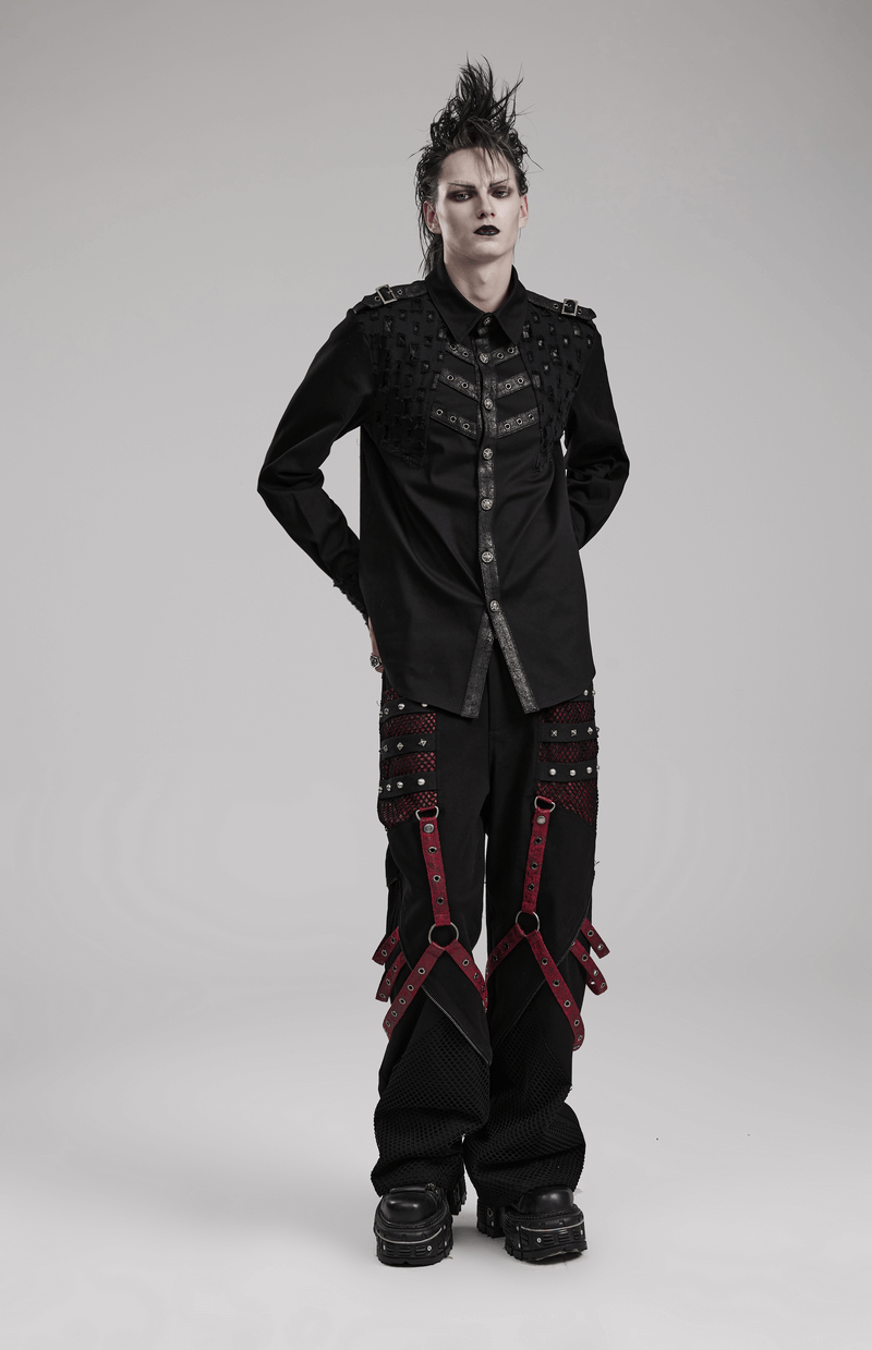 Gothic style model in punk wide leg trousers with detachable straps and a stylish black shirt.