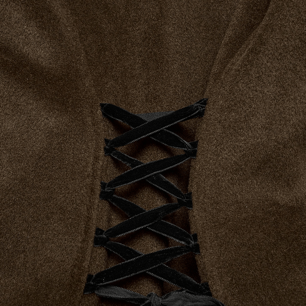 Close-up of gothic coat's lace-up detailing in dark fabric, showcasing vintage-inspired craftsmanship.