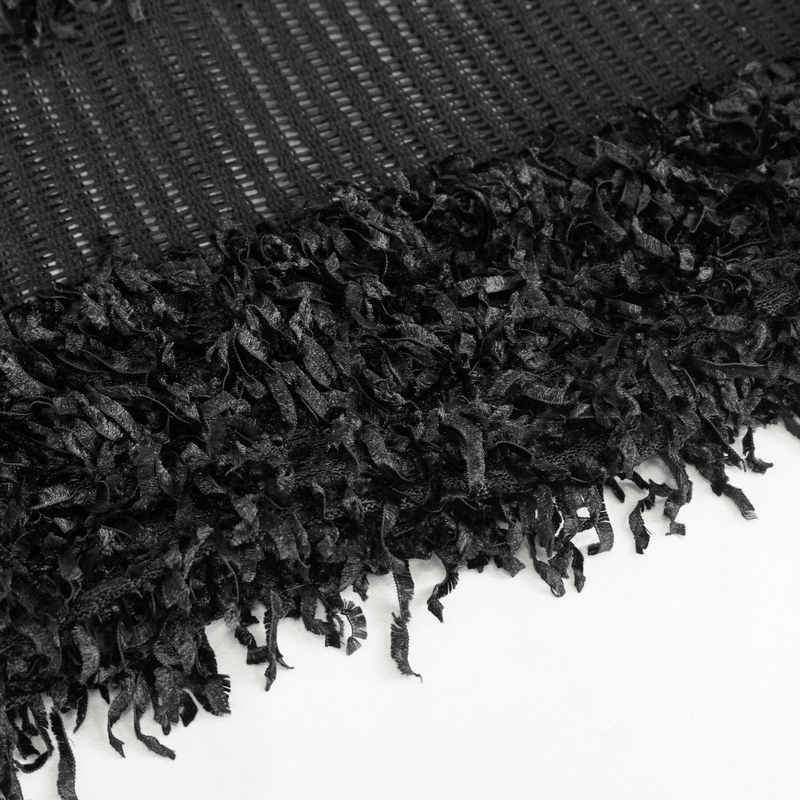 Close-up of gothic distressed sweater fabric showcasing black fringe detailing and sheer texture.