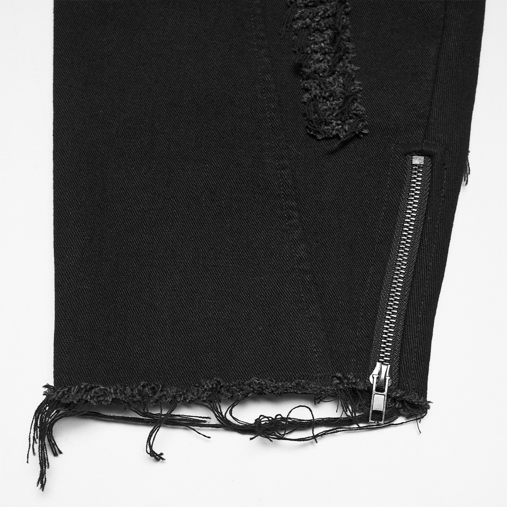 Alt Tag: Gothic Distressed Studded Jeans with Mesh Paneling close-up of black denim zip leg opening with frayed hem and distressed rip