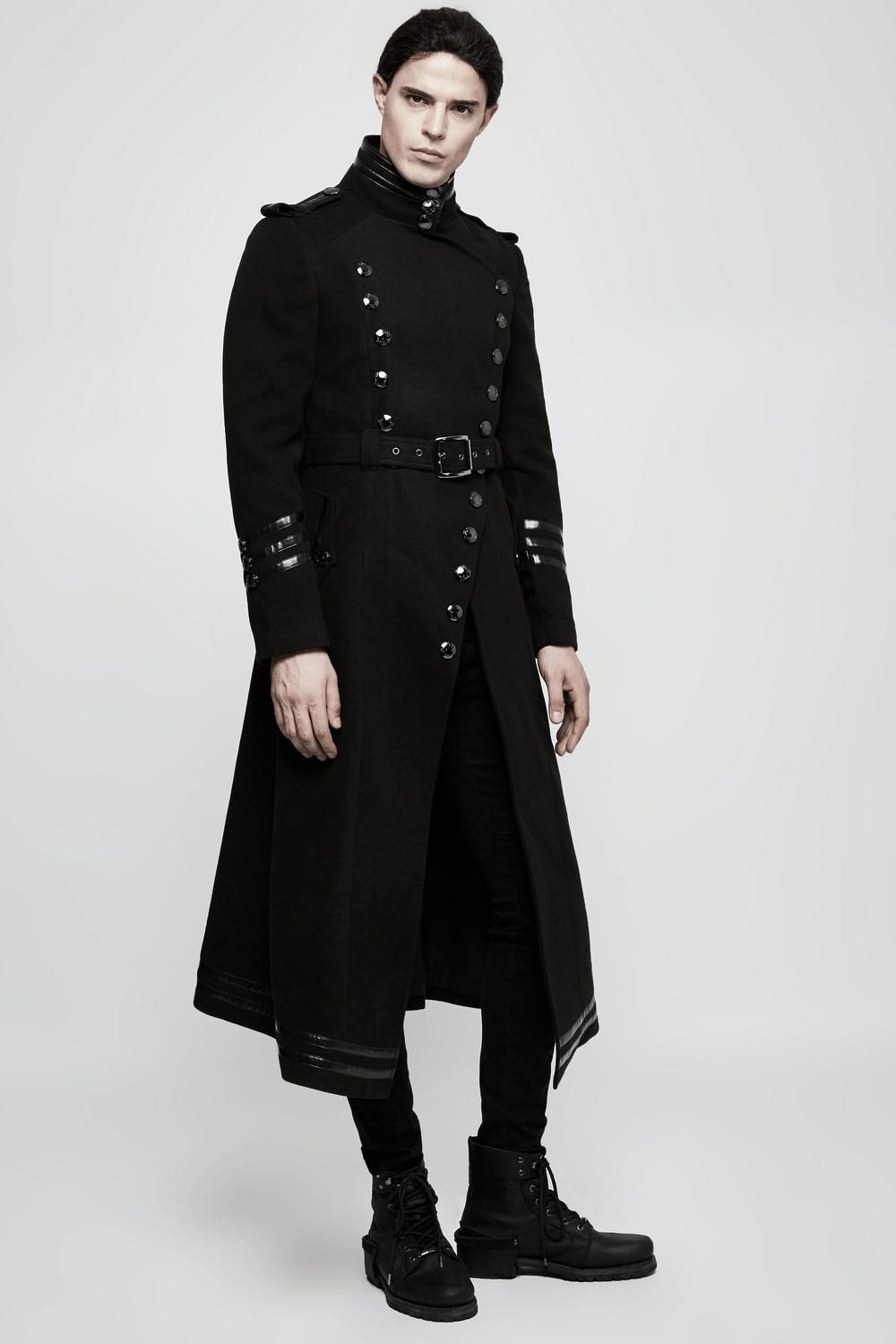 Gothic double-breasted coat with belt and metal accents, featuring asymmetrical design and military-inspired style.