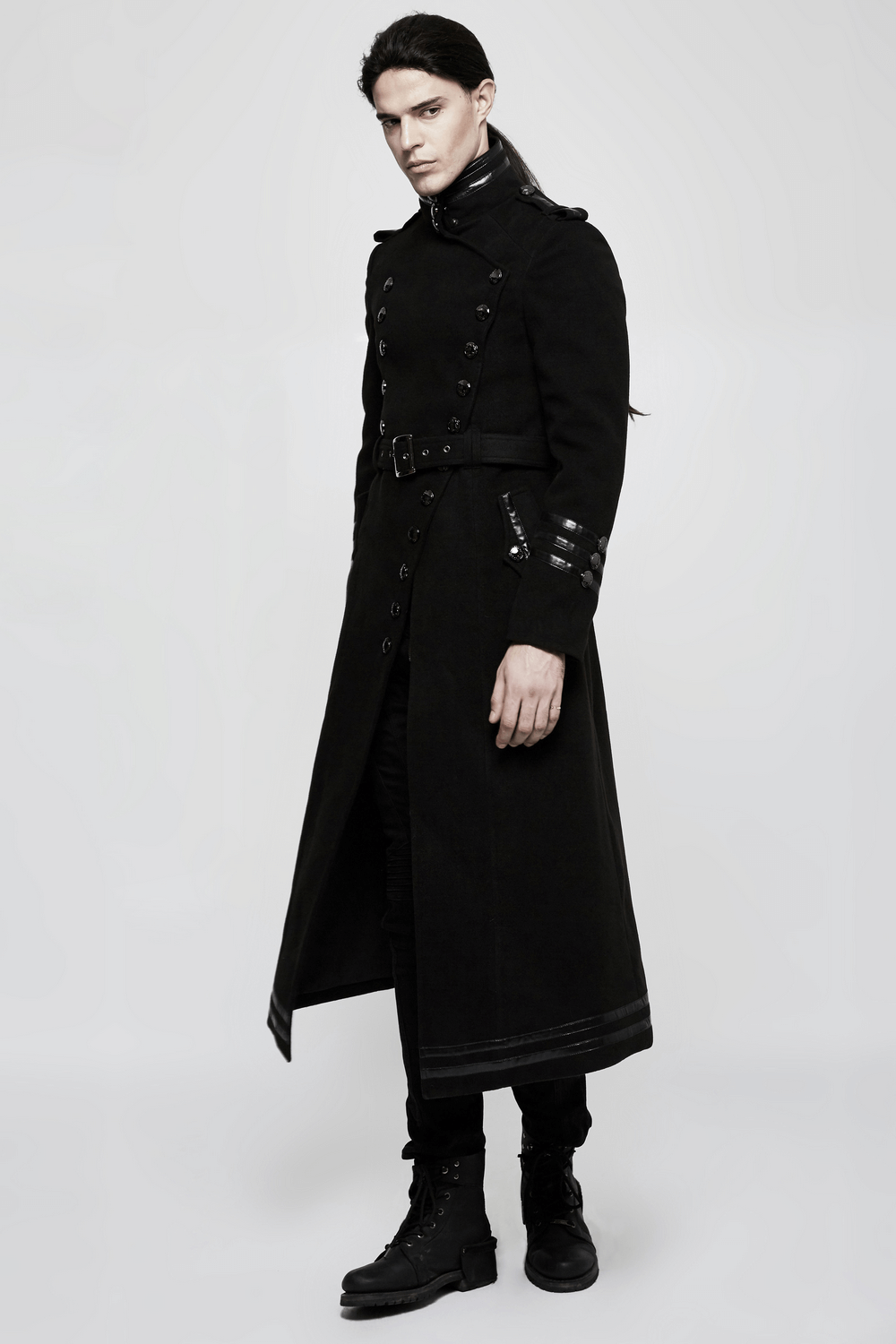 Gothic double-breasted coat with belt and metal accents on a model, featuring military-inspired design and asymmetric placket.