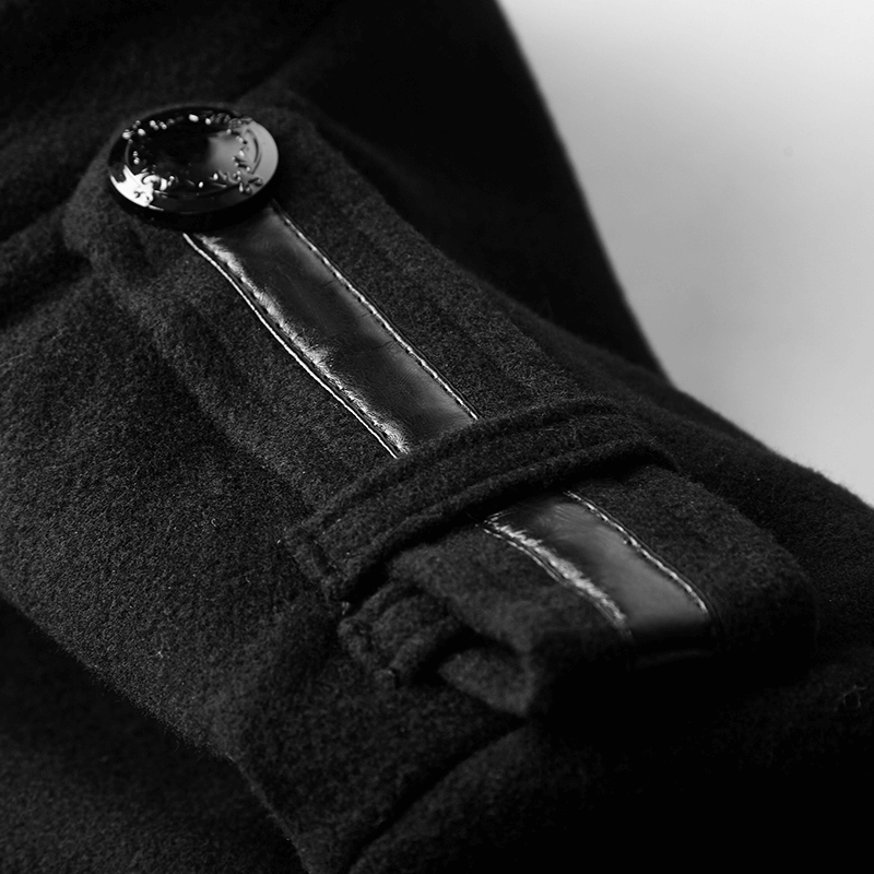 Close-up of gothic coat's black metal button and leather accent, showcasing military-inspired details.