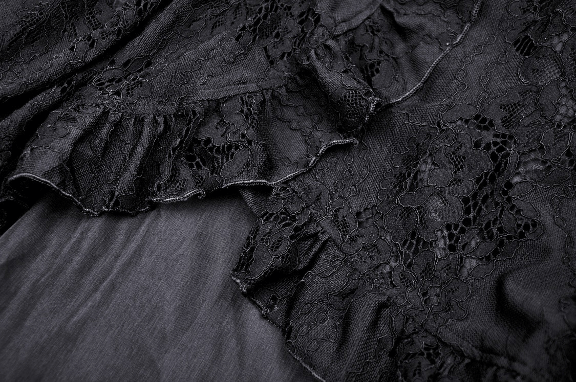 Close-up of black lace fabric with ruffle detailing for a gothic hi-low dress.