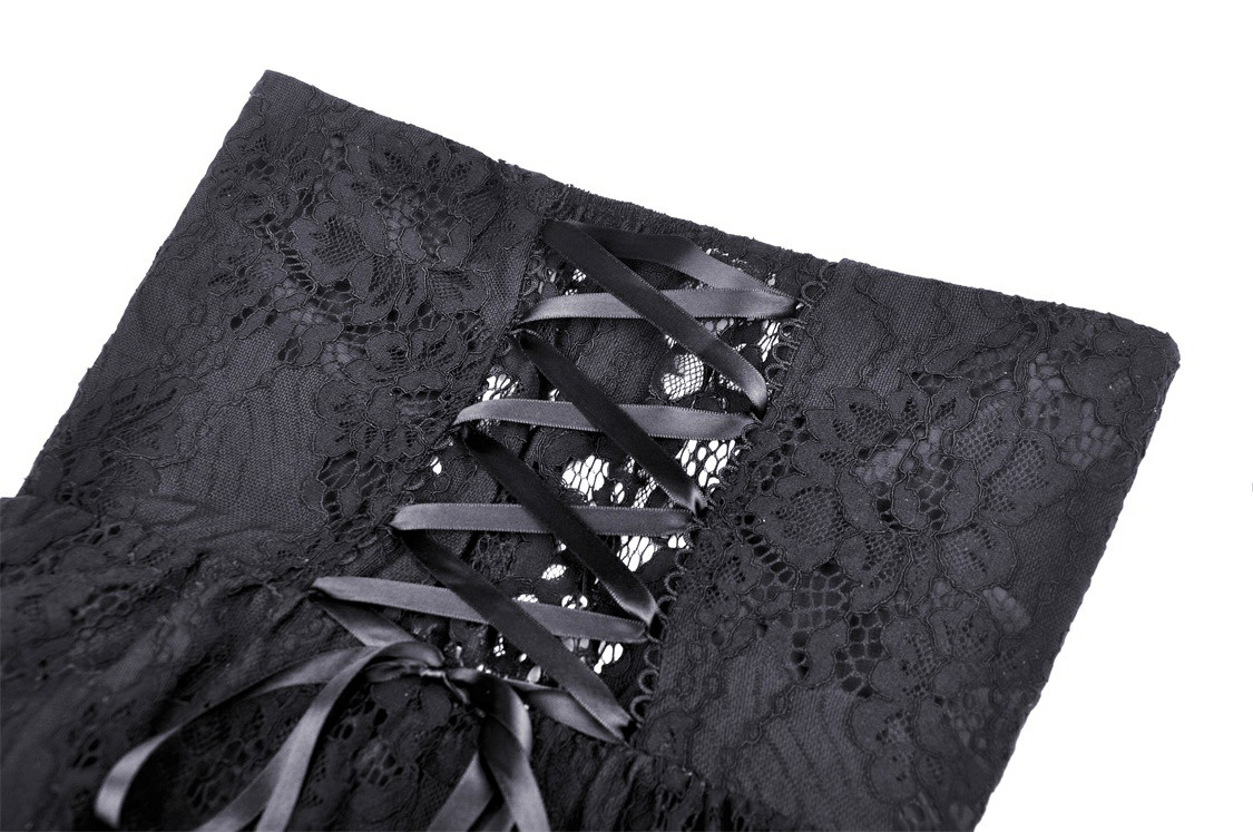 Close-up of gothic black lace dress back with corset-style lacing and satin ribbons for a dramatic touch.