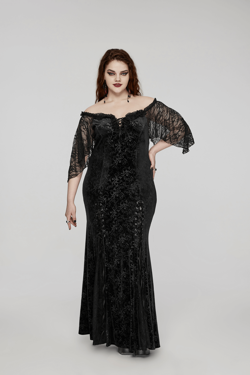 Gothic elegance in a black velvet lace-up long dress with off-shoulder design and delicate ruffle edges.