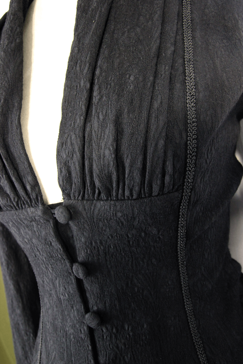 Close-up of a Gothic elegant black deep V shirt for women featuring lace inserts and vintage buttons.