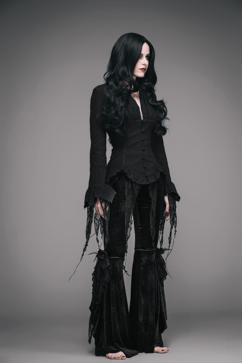 Stylish woman in a Gothic black deep V shirt and flared pants, showcasing elegant vintage couture.