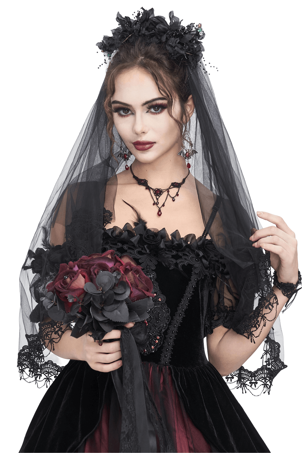Gothic bride wearing elegant black veil with floral hair clip, holding a dark flower bouquet, showcasing a dramatic bridal look.